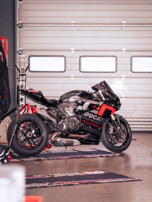Free A sleek Ducati race motorcycle parked inside a garage at Nürburg, Germany. Stock Photo