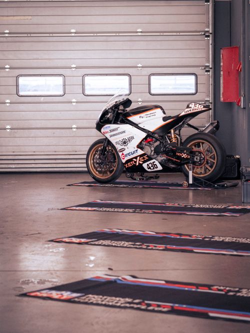 Free Racing motorcycle in a garage at Nürburgring, perfect for motorsports enthusiasts. Stock Photo