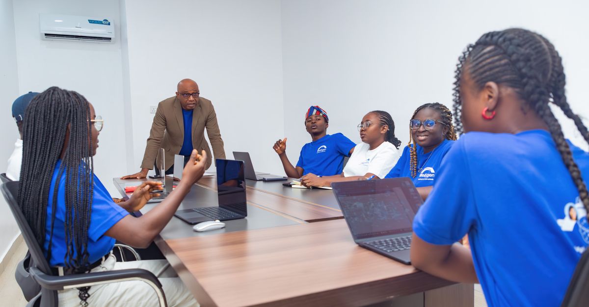 A diverse group of adults collaborating during a business meeting in a modern office setting.