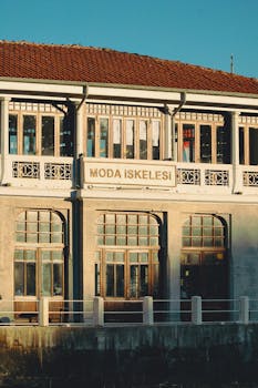 Historic Moda Iskelesi building facade in warm sunlight, showcasing classic architecture in Istanbul.