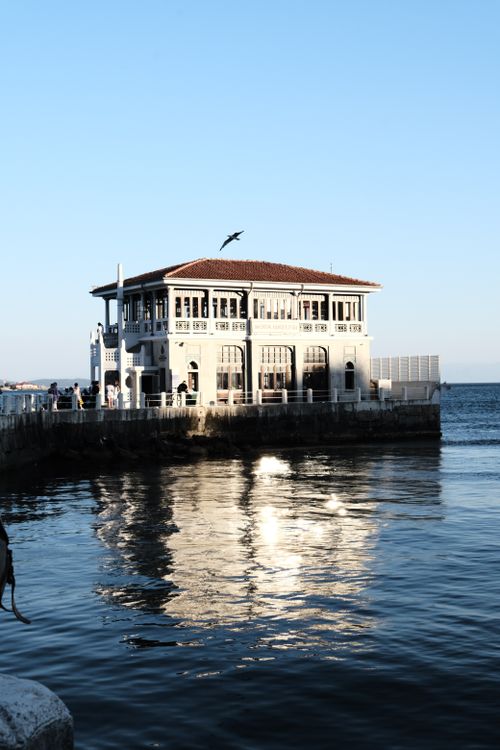 Free Charming historic building by the sea with stunning sunset reflections. Stock Photo