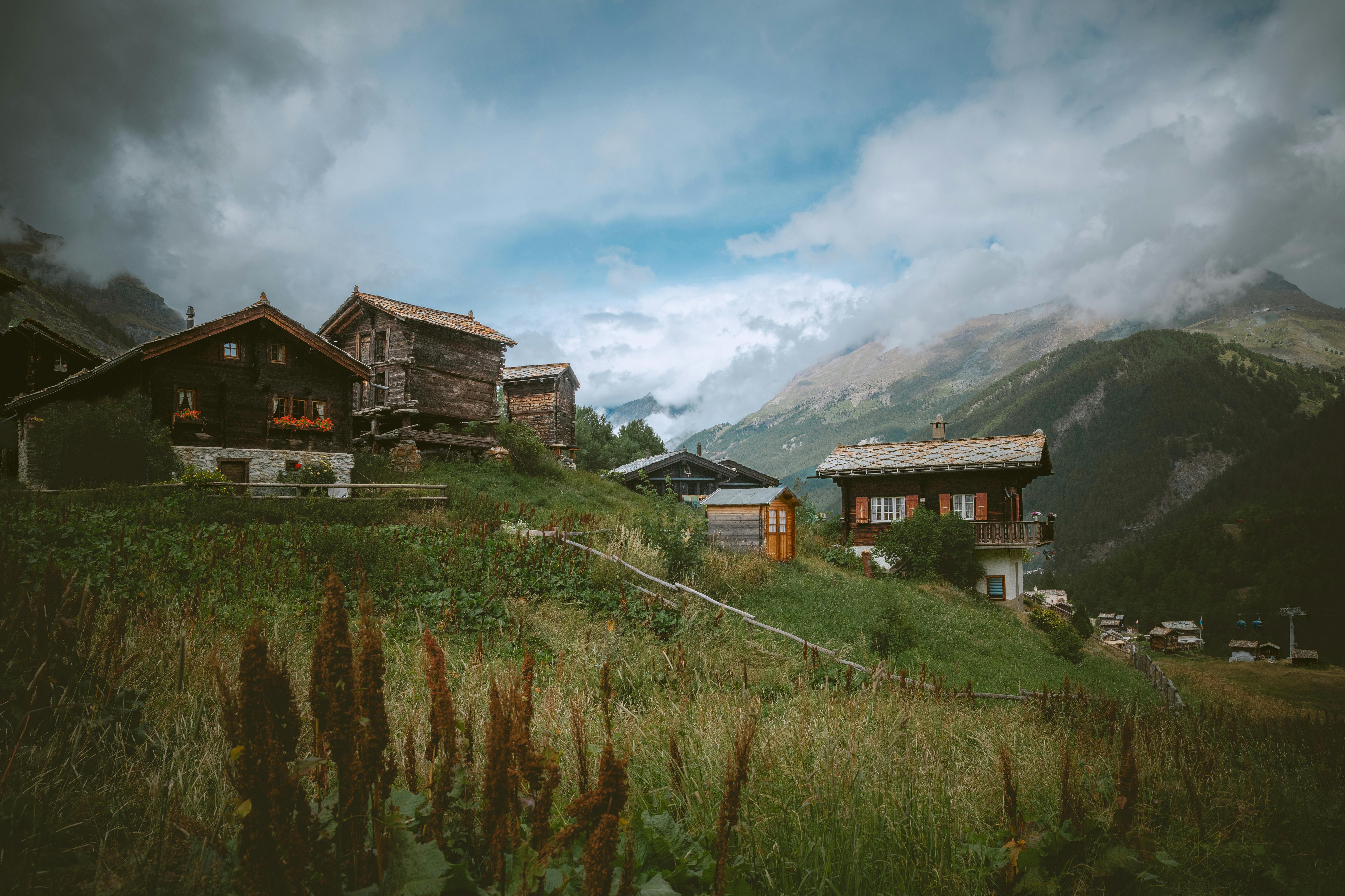 Explore the serene beauty of traditional Swiss chalets nestled in Zermatt's picturesque alpine landscape.