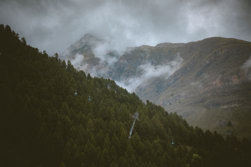 Free A serene view of the foggy Swiss Alps and cable cars in Zermatt, perfect for travel enthusiasts. Stock Photo