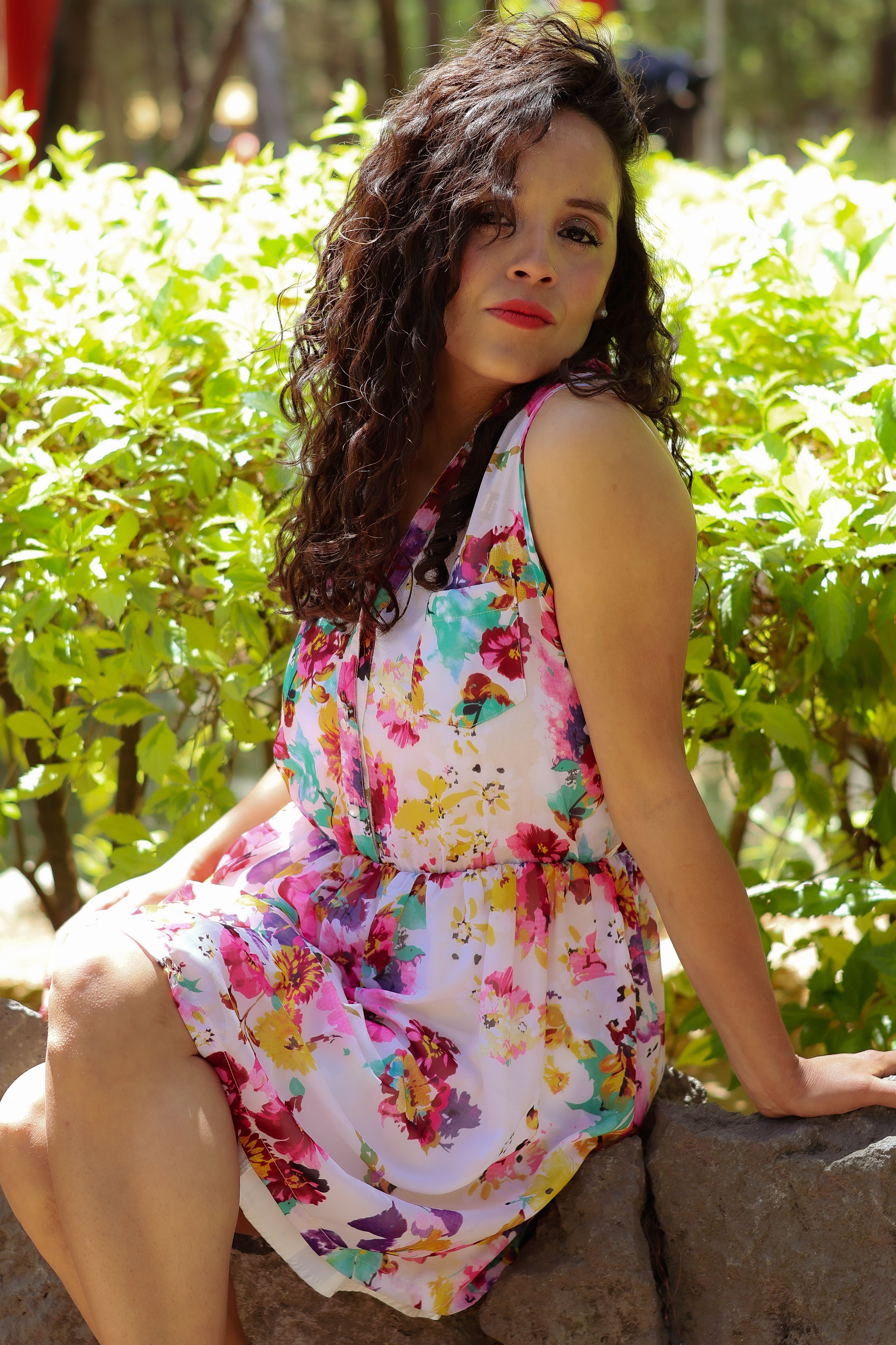 Woman in Floral Dress Posing Outdoors · Free Stock Photo