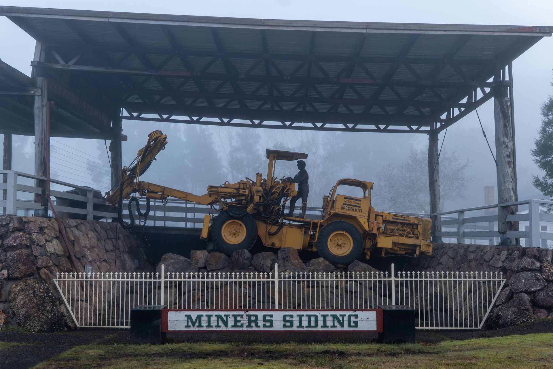 A foggy morning view at Miners Siding with vintage mining equipment in Queenstown, Tasmania.