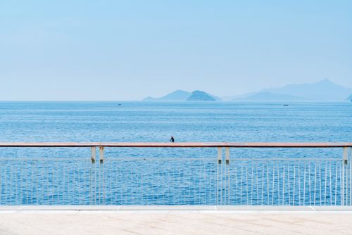 Free A peaceful ocean view from a seaside deck with distant islands. Stock Photo
