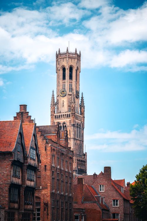 Free Stunning view of the medieval belfry tower in Brugge, Belgium with historical brick buildings. Stock Photo