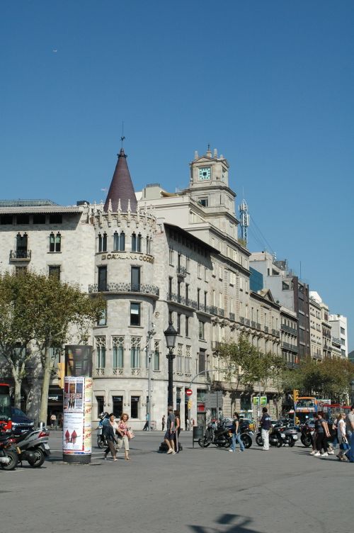 Free Vibrant street view in Barcelona featuring historic buildings and lively urban life. Stock Photo