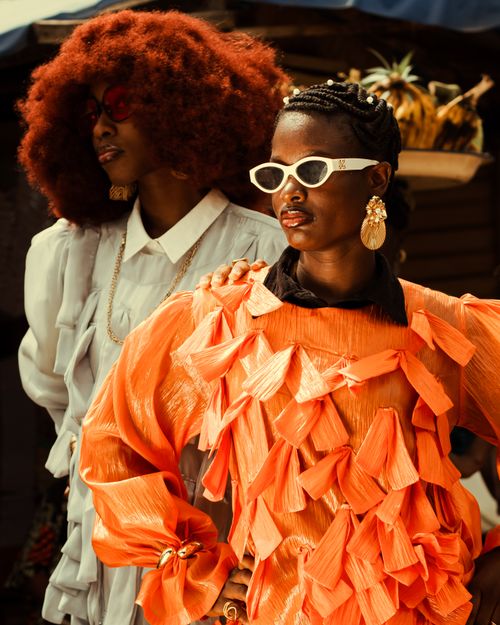 Free Vibrant fashion portrait featuring two women showcasing bold styles in colorful attire and sunglasses, posing with confidence. Stock Photo
