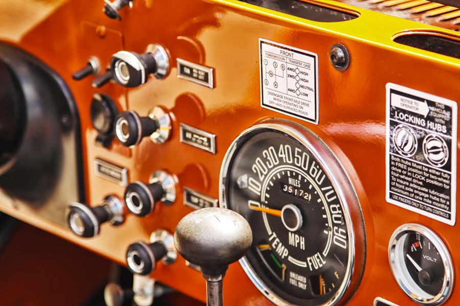 Close-up of a car dashboard with gauges and controls