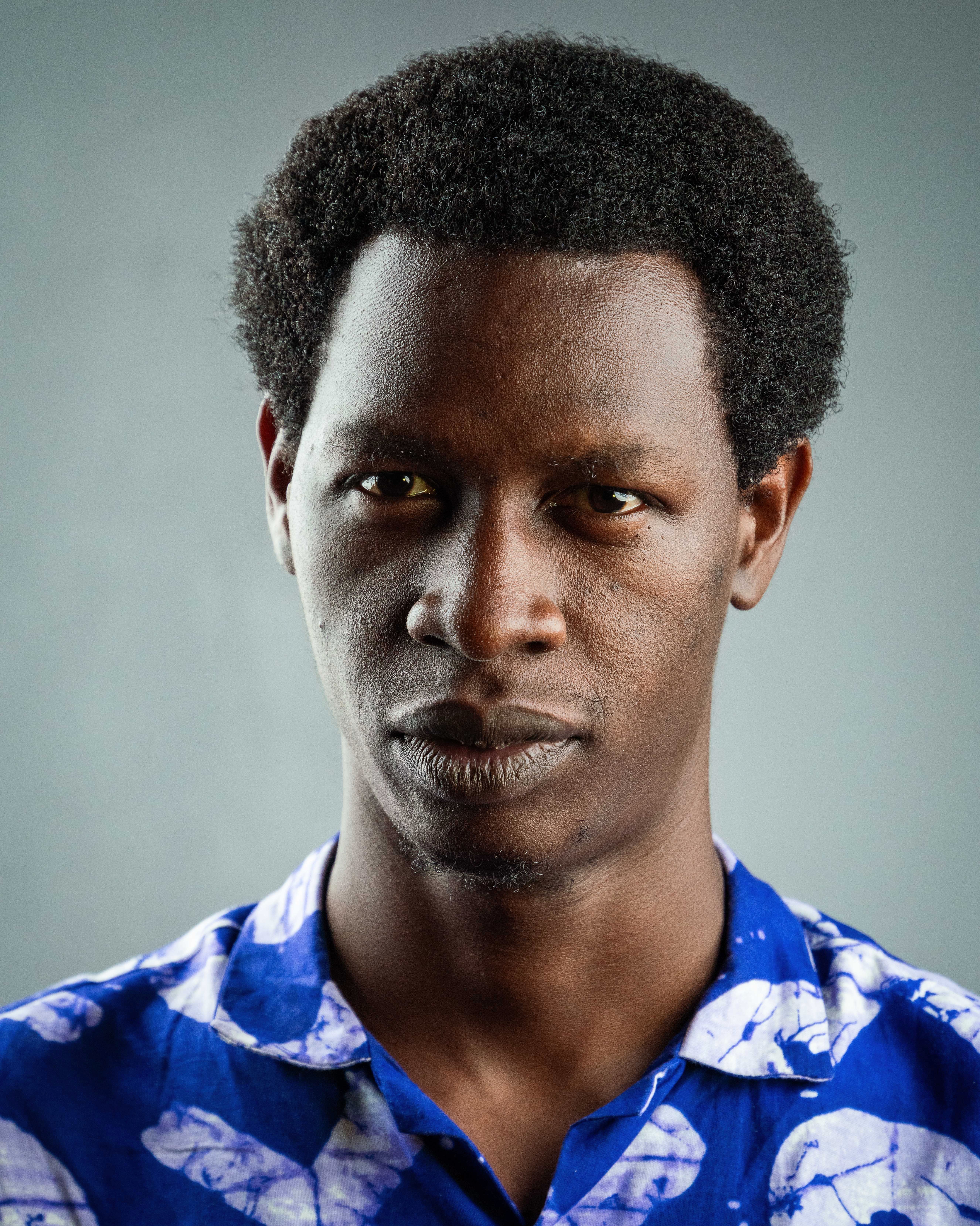 Portrait of confident young man in blue shirt · Free Stock Photo
