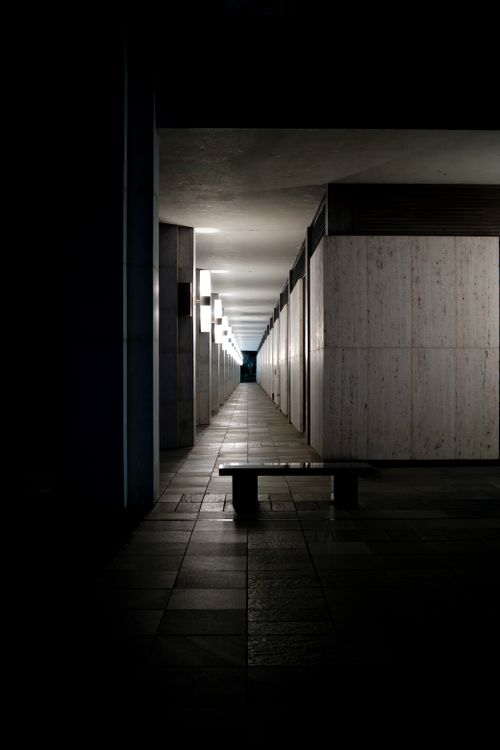 Free Moody corridor with dramatic lighting in Canberra, Australia, showcasing modernist architecture. Stock Photo