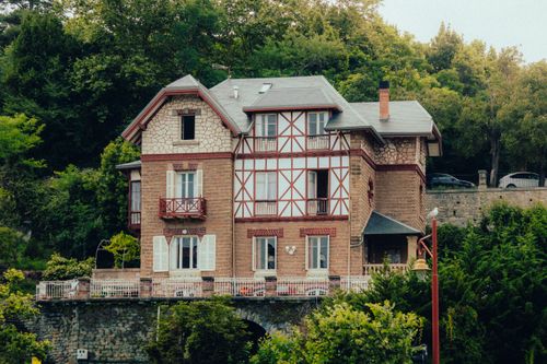 Free Elegant Basque-style villa in Zumaia surrounded by rich greenery, showcasing unique architectural charm. Stock Photo