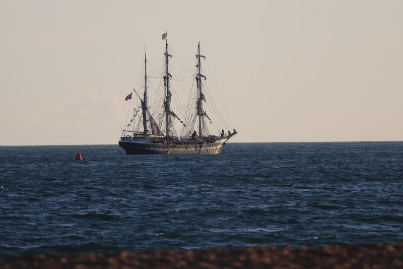 A tall ship under sail on the open sea at dusk — photo by Carel Voorhorst on Pexels