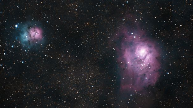 A captivating image of the Lagoon and Trifid Nebulae amidst a starry night sky.