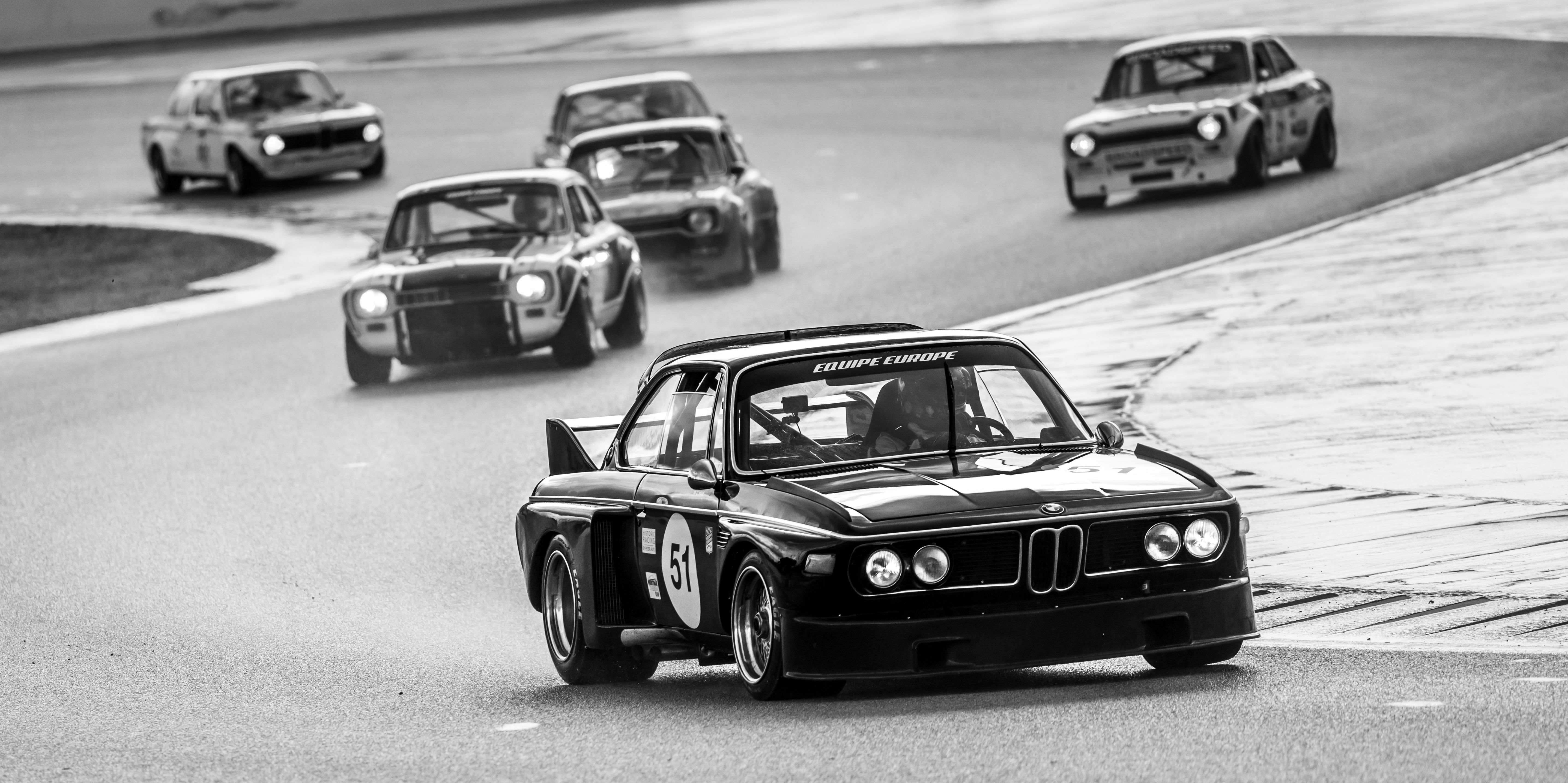 Black and White Vintage Car Race on Wet Track · Free Stock Photo