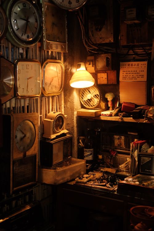 Free Cozy vintage workshop full of clocks under warm lighting, creating a nostalgic atmosphere. Stock Photo