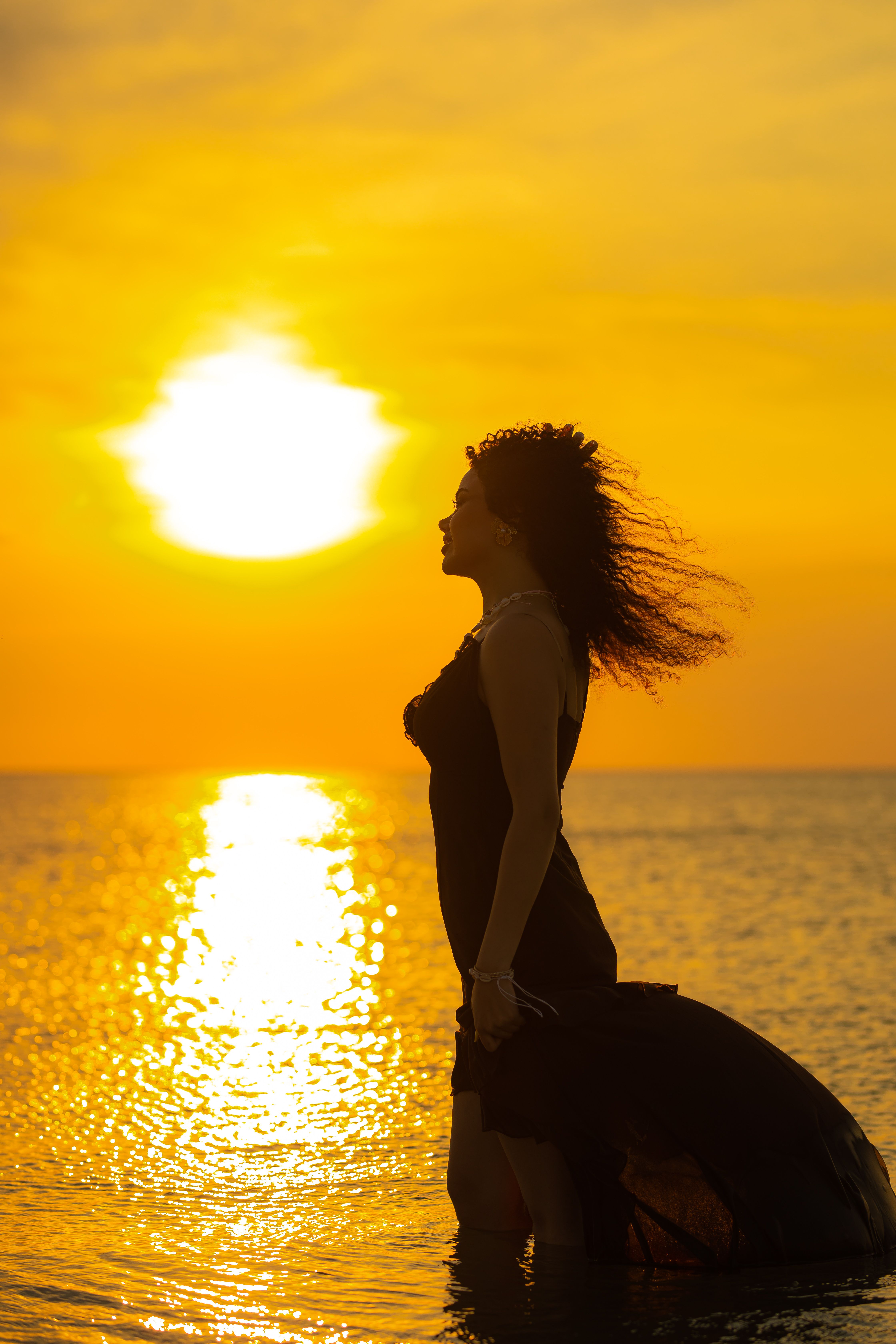 Silhouette of Woman at Sunset by the Sea · Free Stock Photo