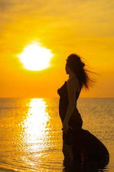 Captivating silhouette of a woman in a dress at sunset over the sea in Azerbaycan.