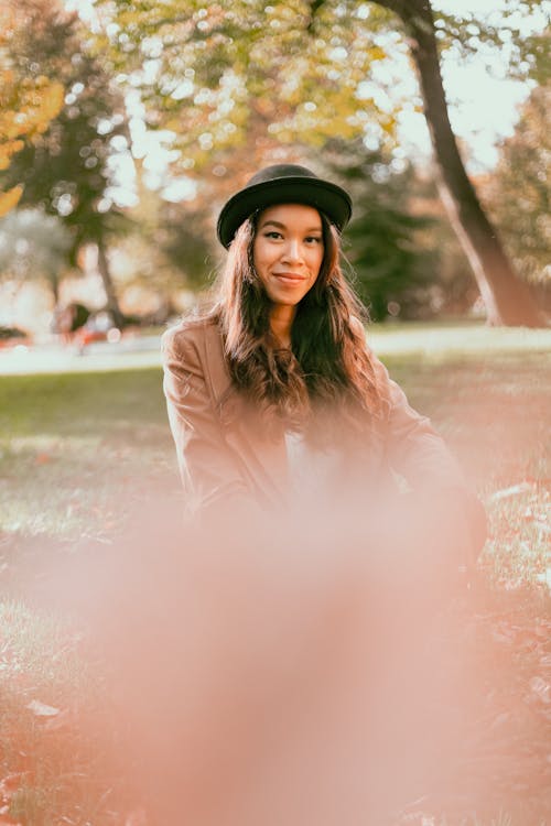 Woman Wearing Brown Jacket and Hat
