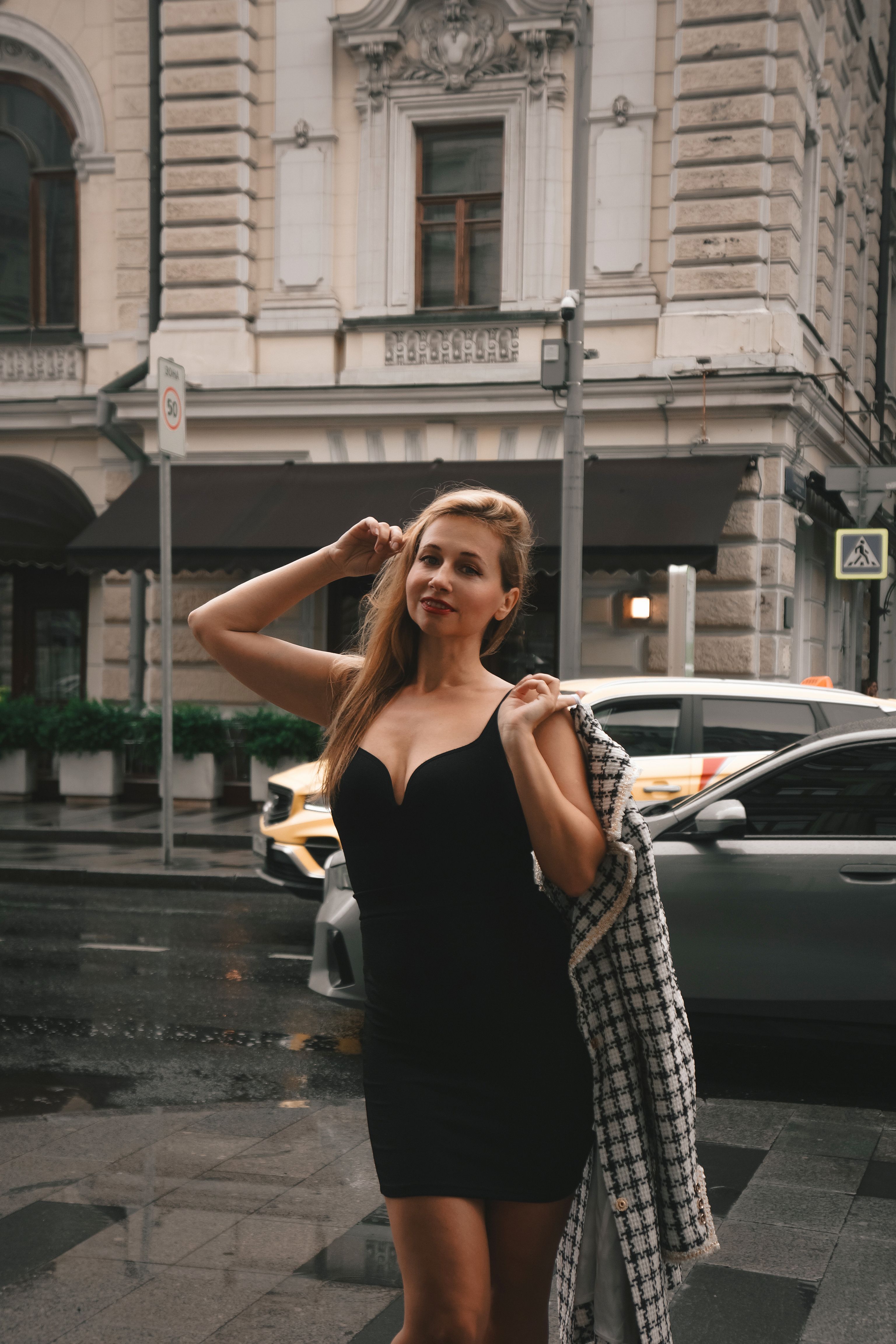 Elegant Woman in Black Dress on City Street · Free Stock Photo