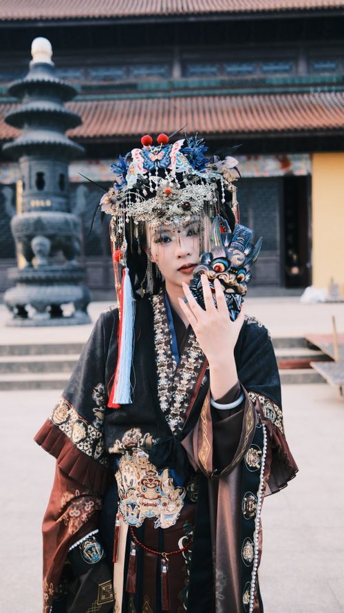 Free Portrait of a person in ornate traditional Asian attire and headdress in a temple setting. Stock Photo