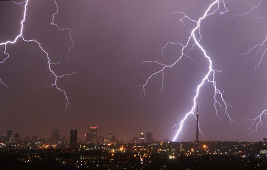 Breathtaking lightning storm illuminating the Johannesburg city skyline during night time, showcasing dramatic weather.