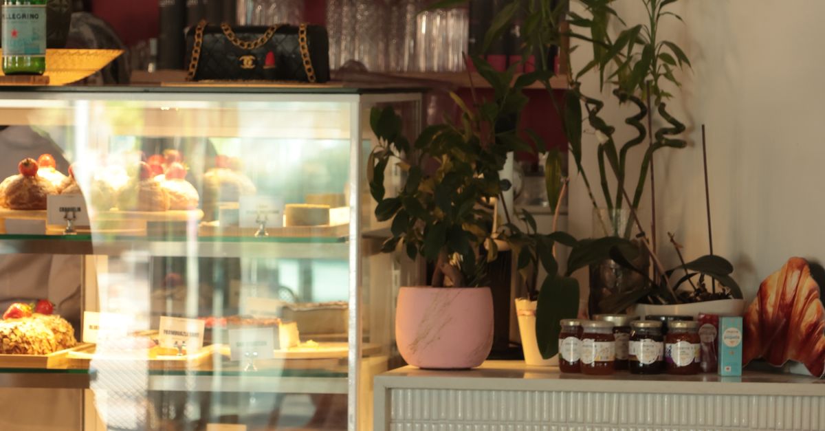 Cozy Cafe Interior with Pastry Display · Free Stock Photo