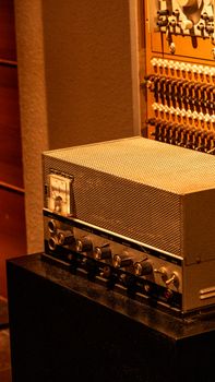 Close-up of vintage audio equipment and control panel in warm lighting.