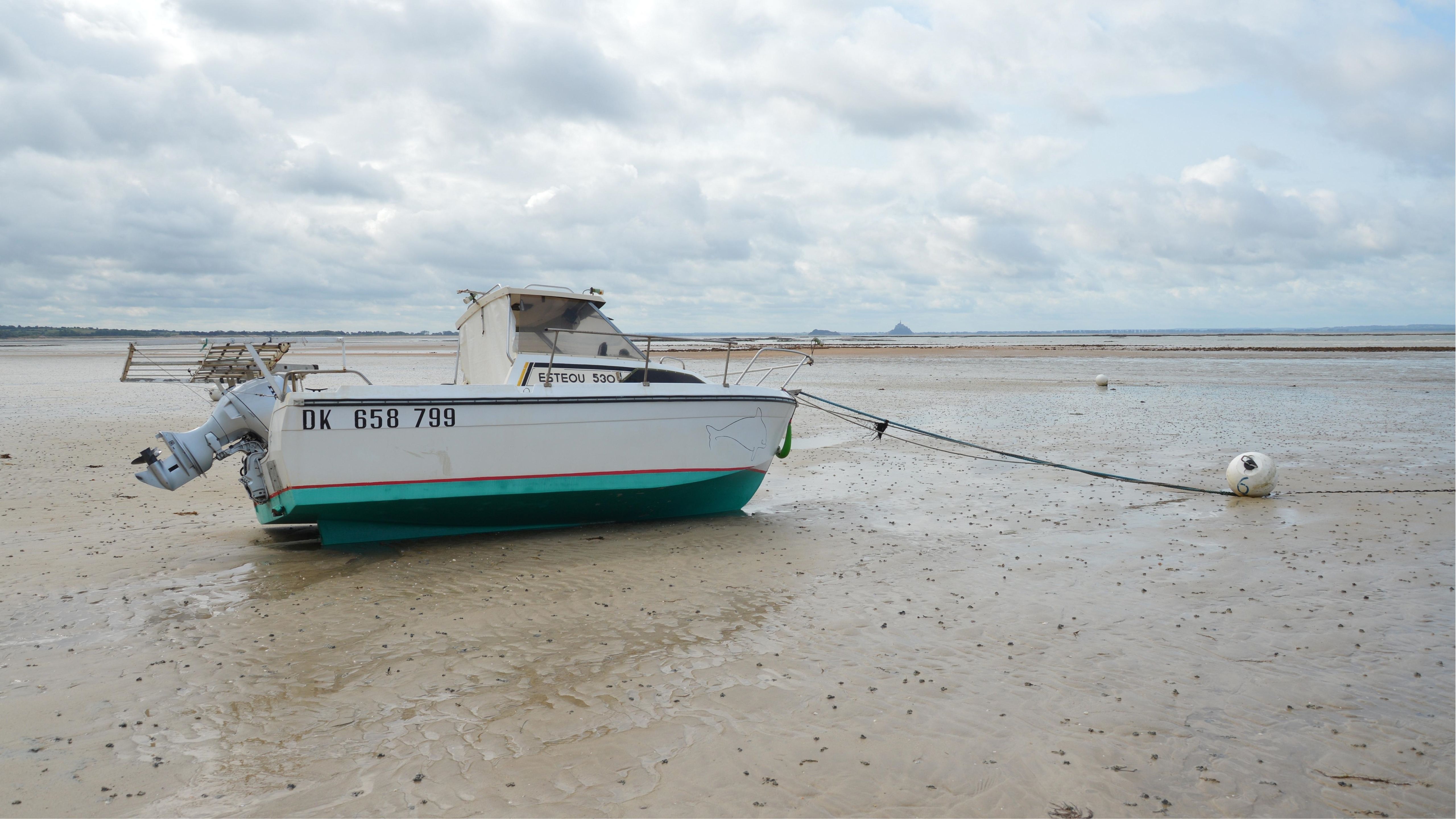 Fishing Boat Beached on the Shoreline of Normandy · Free Stock Photo