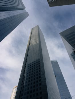 A low-angle view of modern skyscrapers under a bright sky in downtown Houston, Texas.