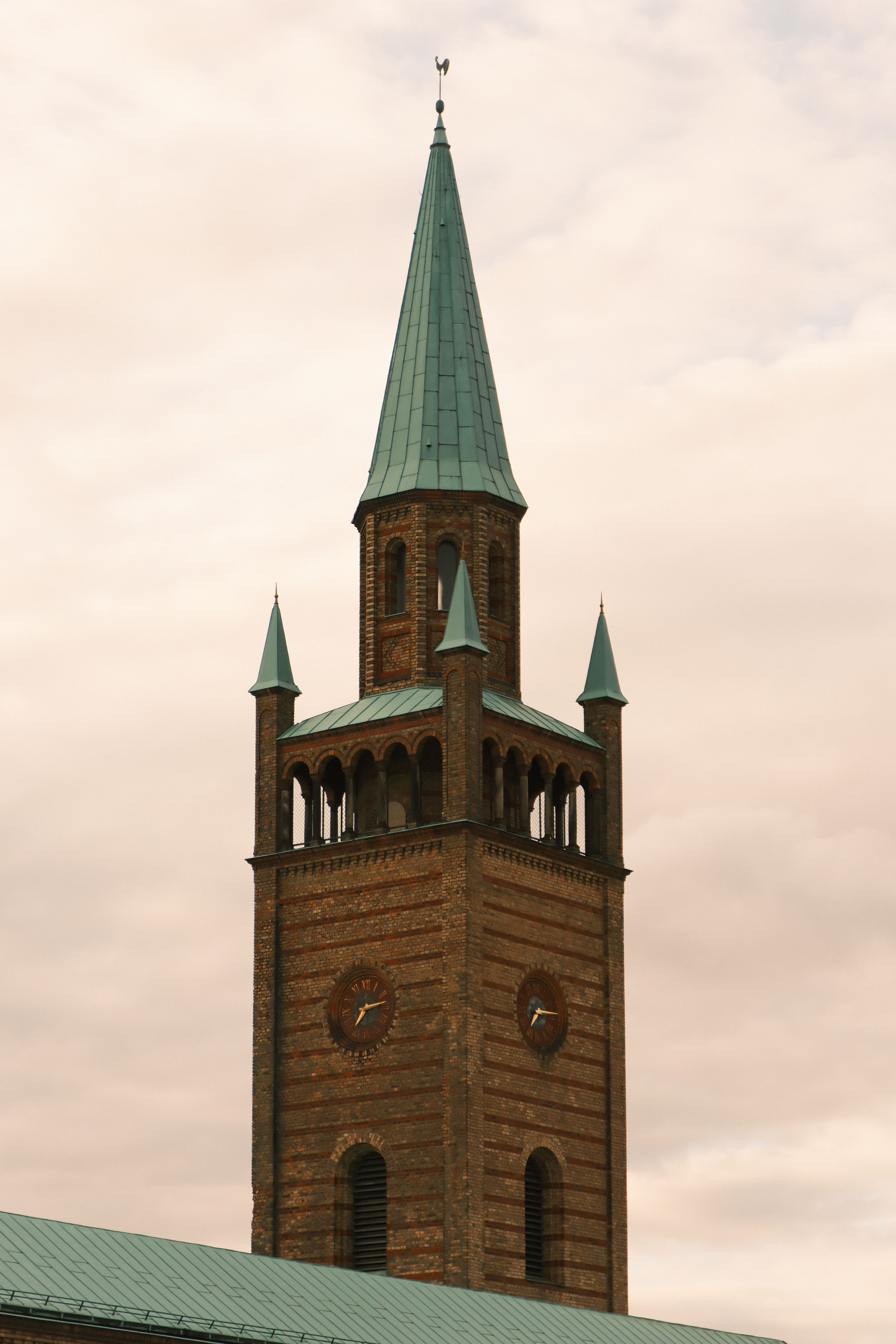 Historic Brick Clock Tower Against Cloudy Sky · Free Stock Photo
