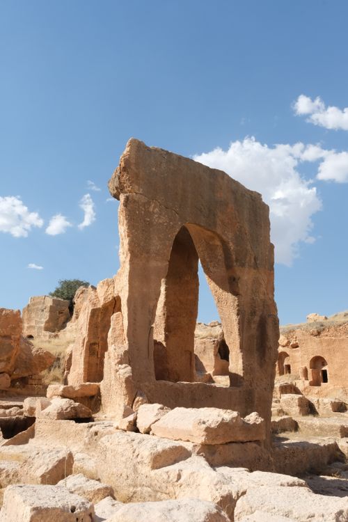 Free Explore ancient rock ruins with monumental arches under a clear blue sky. Stock Photo