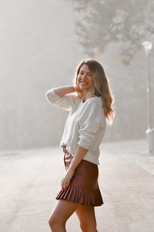 Free Photo of Woman Wearing White Sweater and Brown Leather Mini Skirt Stock Photo