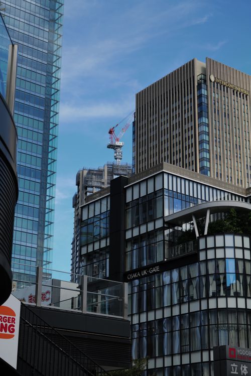Free Contemporary buildings in Osaka's skyline with blue sky background. Stock Photo