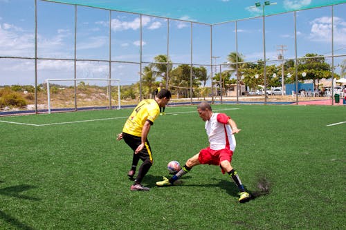 Men Kicking a Soccer Ball