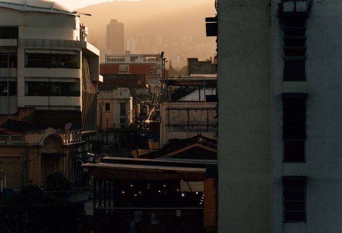 A stunning view of San Salvador's cityscape at sunset, capturing historic and modern architecture.