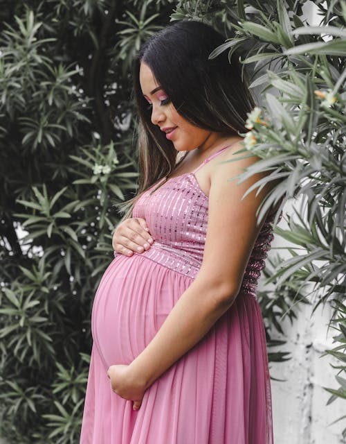 Pregnant Woman Standing Near Plants