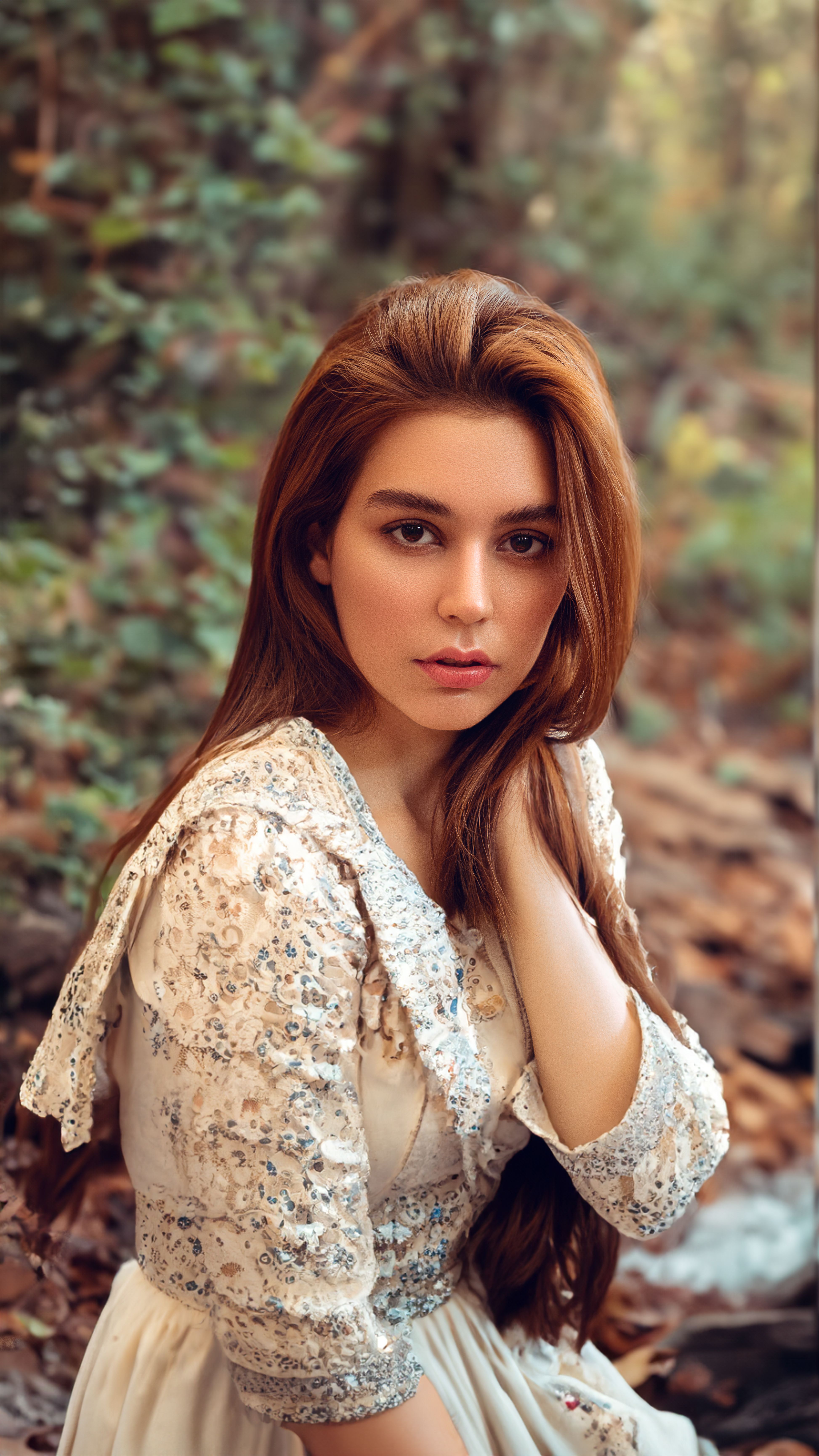 Elegant portrait of a woman in vintage dress set in a serene autumn forest setting.