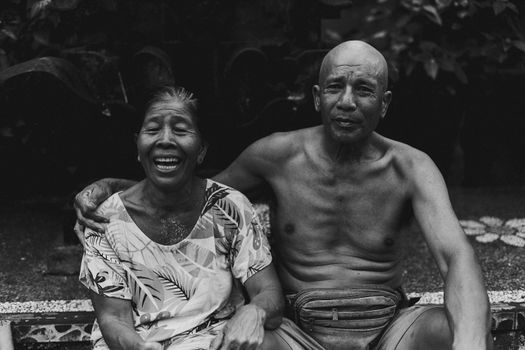 A joyful elderly couple captured in a candid, warm moment, sharing smiles.