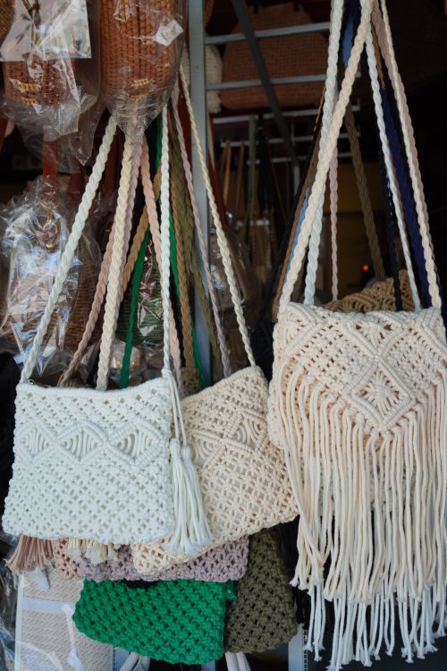 Free Beautiful handmade macramé bags on display at an artisan market, showcasing intricate patterns and natural textures. Stock Photo