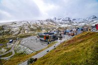 A snow-dusted mountain town with parking lot and scenic roads on a clear day.