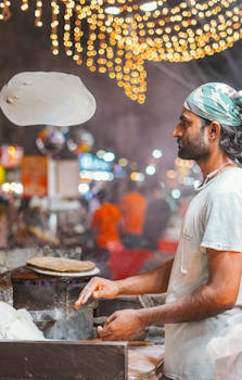 Authentic street food vendor making naan at a lively night market in South Asia, capturing cultural essence.