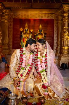 Couple in traditional attire at a Hindu wedding ceremony in Hyderabad.