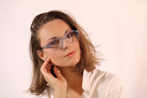 Free Portrait of a professional woman wearing stylish glasses, exuding confidence and elegance. Stock Photo