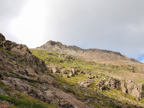 Free Vibrant daytime view of jagged mountains and green valleys in Snowdonia, Wales. Stock Photo