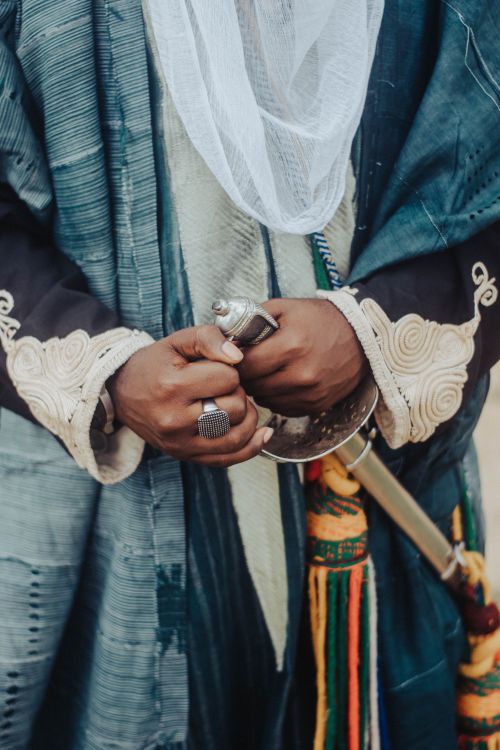 Free Close-up of hands holding a traditional sword in African attire, showcasing rich cultural heritage. Stock Photo
