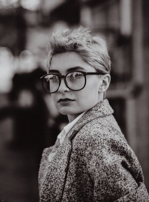Free A stylish black and white portrait of a woman with glasses, ideal for editorial use. Stock Photo