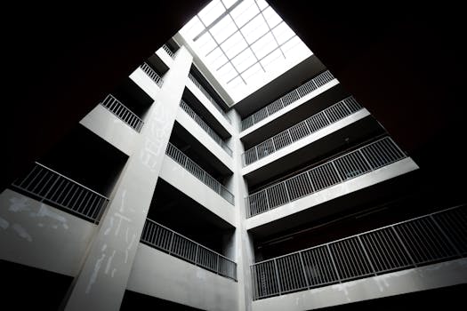 High angle view of a building's atrium with geometric skylight and railings.