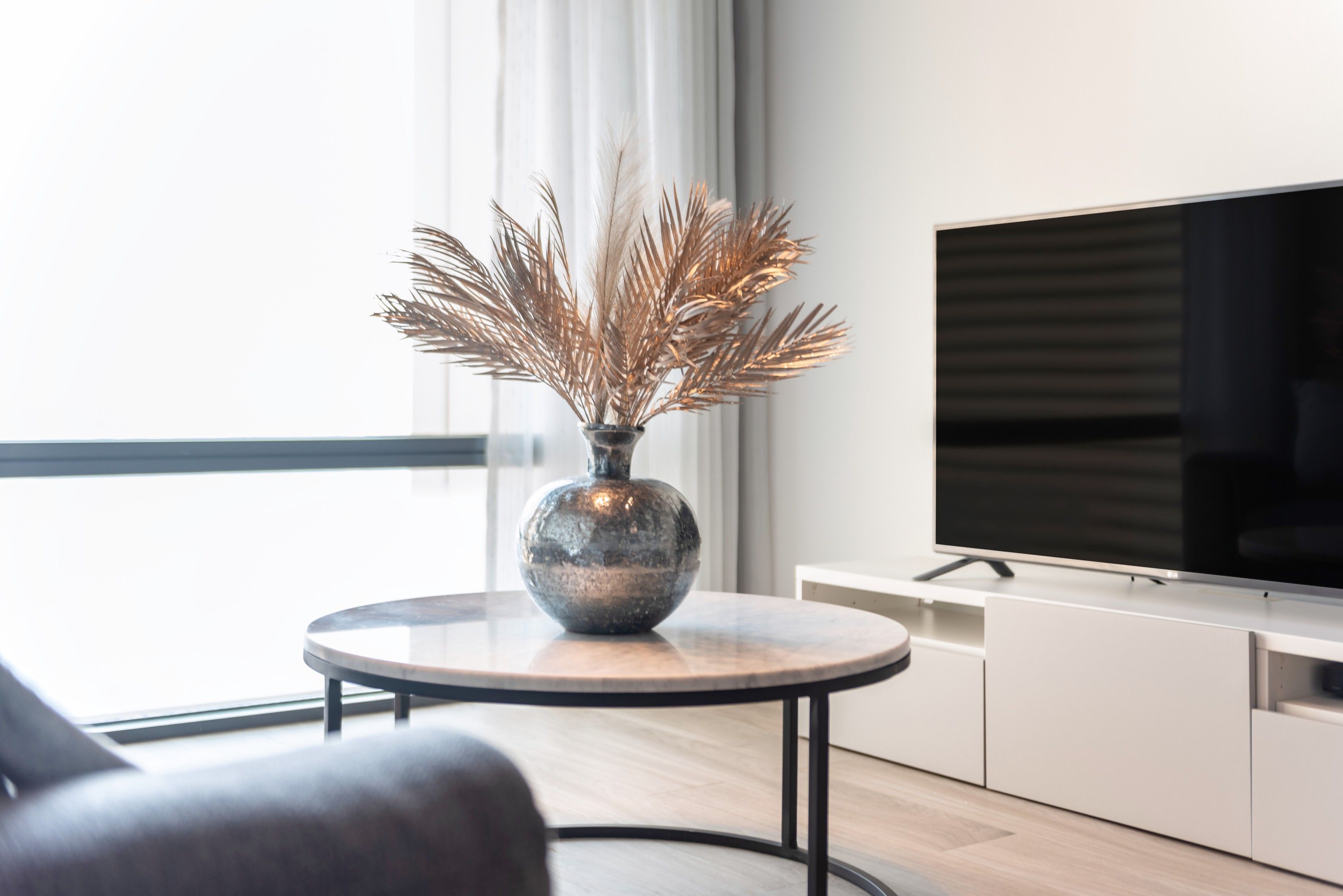 Modern vacation rental living room with neutral decor and large window